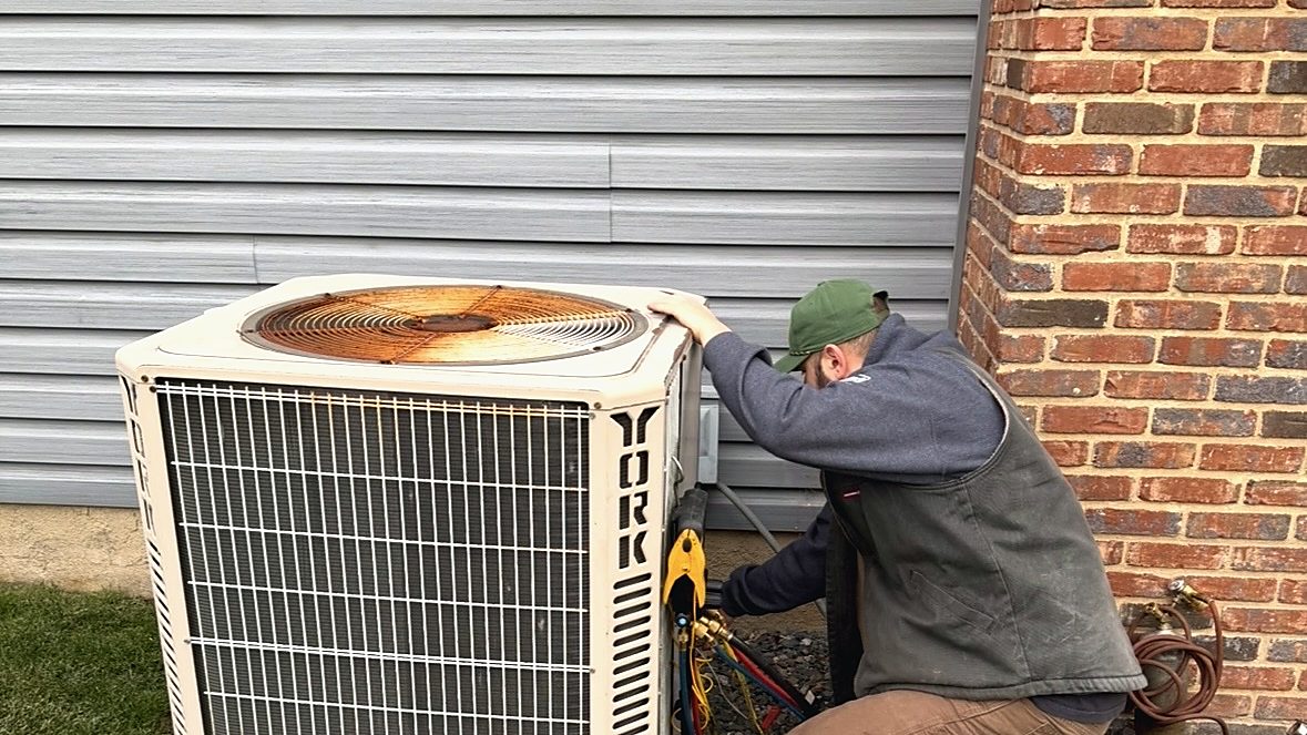 Evan of Edge Mechanical servicing a York AC condenser at a Bucks County home